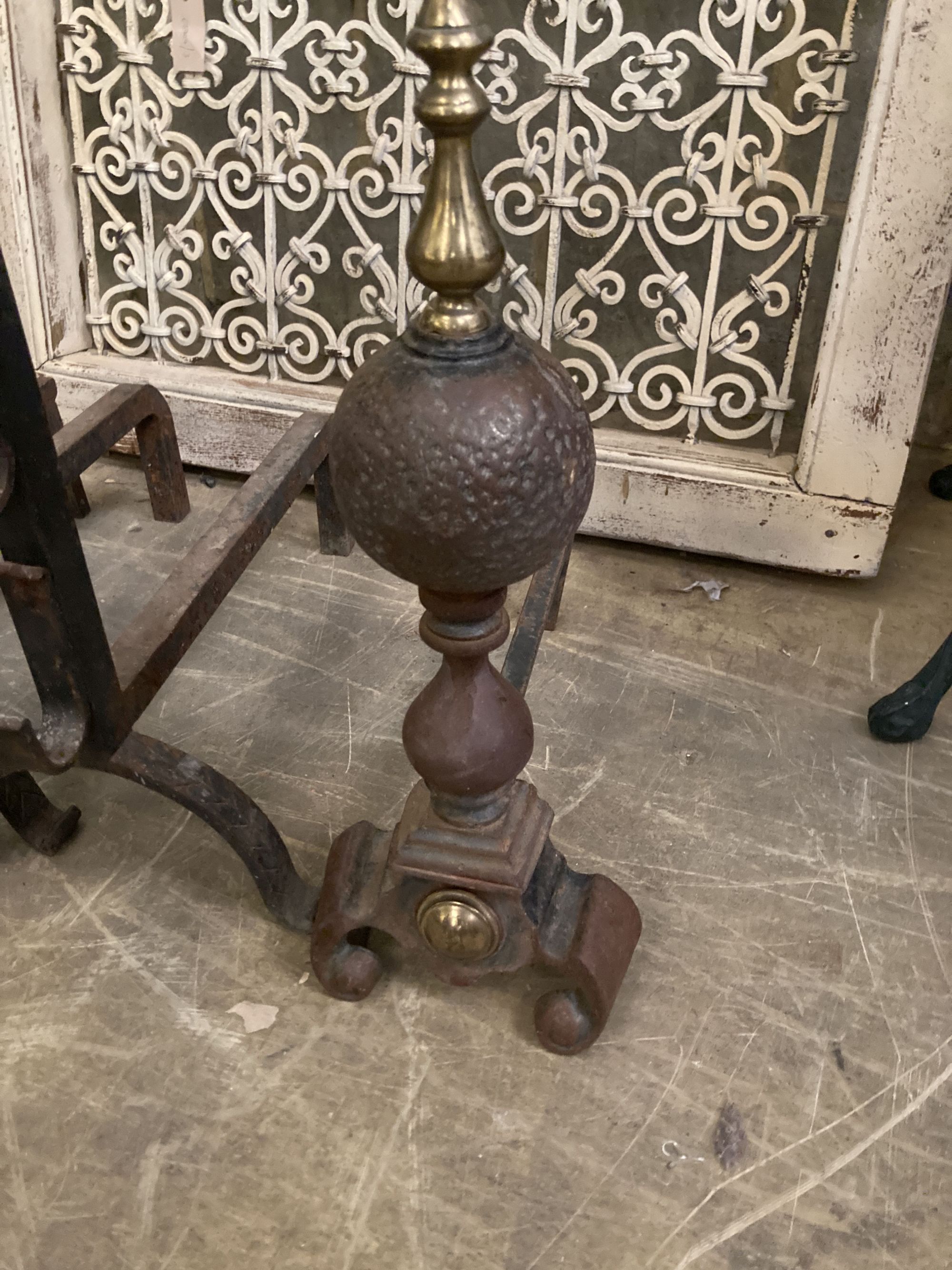 A pair of Victorian wrought iron fire dogs, together with one other pair of brass mounted fire dogs, largest 73cm high